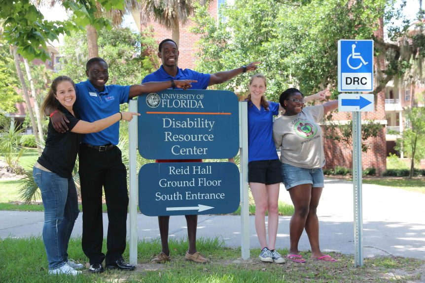 Students standing in front of a sign