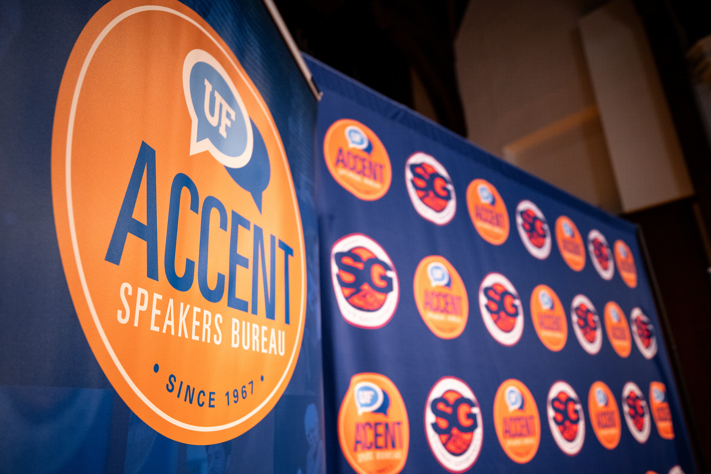 UF Student Government Accent speakers series back drop on the stage in the university auditorium.